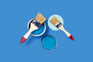Brush and pain can on a blue background. photo