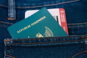 Indonesia in July 2022. An Indonesian passport and a Turkish Airlines boarding pass in a jeans pocket. photo