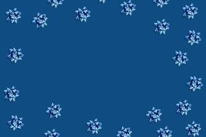 Holiday blue background with circle frame of blue bows. photo