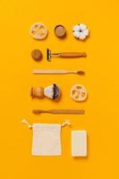 Zero waste accessories on yellow background. photo