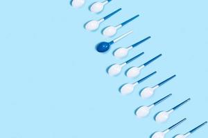 Pattern of withe spoons on blue background. photo