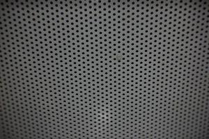 photo of a small hole in the back of an iron chair can be used as wallpaper or background.