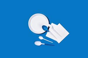 Photo with white spoons on blue background.