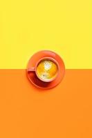 One cup of coffee on two-toned background. photo