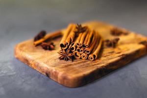Cinnamon and cloves on grey background. photo