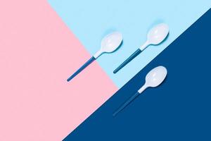 Three plastic spoons on color background. photo