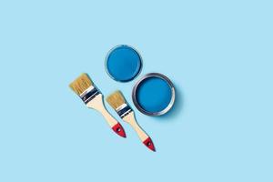 Paints and brushes on a blue background. photo