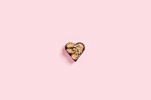 The cookie cutter on a pink background. photo