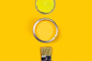 Yellow background with color paint jar. photo
