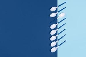 Plastic spoons on blue background. photo