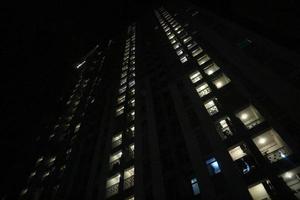 Conditions at night where you can see neatly arranged light rays coming from an apartment photo