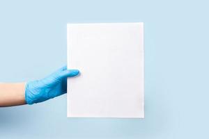 A blue background with hand holding a box of food. photo