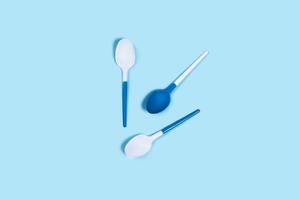 Picture of white spoons on blue background. photo