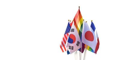 Isolated rainbow flags and flags of many countries, cloudy and bluesky background, clipping paths, concept for celebration of lgbtqai genders in pride month around the world, soft and selective focus. photo