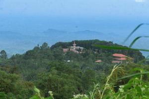 A view of Medan city from a height place in Sibolangit North Sumatera, with some objects of the church in the midground photo