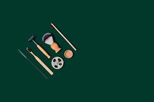 Zero waste accessories on green background. photo