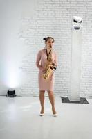 Beautiful girl playing saxophone photo