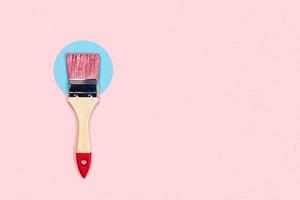 Color background with pink paint brush. photo