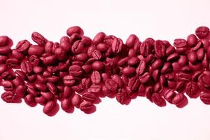 Isolated roasted magenta coffee beans in harsh light photo