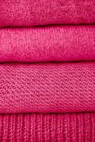 stack of magenta knit sweaters photo