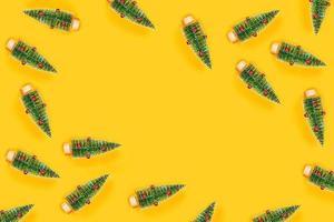 Yellow background with christmas trees. photo