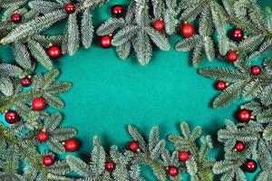 Christmas background with fir branches and red balls. photo