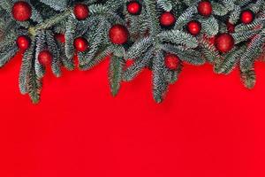 Christmas background with red balls on fir brunches. photo