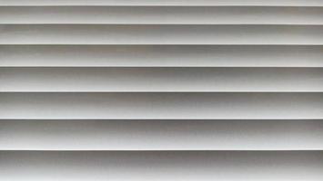 Window blinds with wavy gray striped background photo