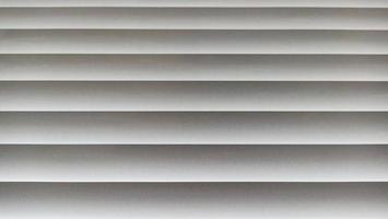 Window blinds with wavy gray striped background photo