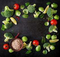 Fresh vegetables for a healthy diet on a dark background in a rustic style. Vegetarian food. Top view photo