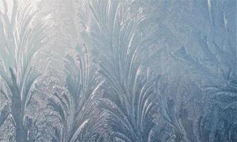 Frost on the window. Frost pattern on glass. Abstract frost ornaments. photo