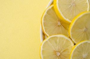 Lemon slices on yellow background. Round lemon slices. photo