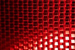 red background - detail of a red traffic warning lamp. The brake light assembly of a modern automobile photo