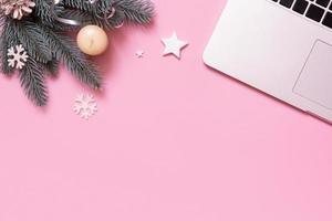 Blank work table and Cristmas New Year decoration top view, flat lay on pink background. Business xmas concept. photo