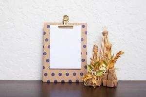 Mock up tablet with blank sheet paper and Christmas New Year decorations still life. Xmas text blank photo