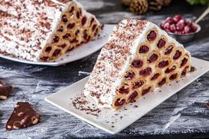 A traditional Moldavian dessert or cake consisting of pancakes with cherry, milk creme and chocolate creme also called Cosma lui Guguta. photo