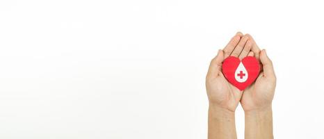 Hands holding heart for giving life paper cut on white background, Blood transfusion, World blood donor day. Blood Donation Concept photo