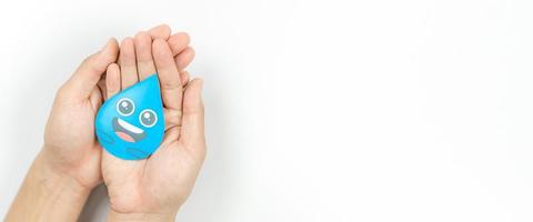 Hands holding water drop paper cut, Washing hand, Hand sanitizer and Hygiene. World water day, Saving water and world environmental protection concept photo