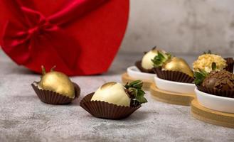 Heart shaped box with assorted chocolate covered strawberries on a gray background.St Valentine's,mother's day,8 march.Side view photo