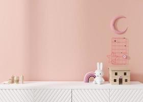 Empty pink wall. Mock up kids room interior in contemporary style. Close up view. Free, copy space for your picture or other small object. Sideboard, toys. 3D rendering. Child room mock-up. photo