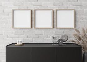 Three empty square picture frames on white brick wall in modern living room. Mock up interior in minimalist, contemporary style. Free space for your picture, poster. Console, sculptures. 3D rendering. photo