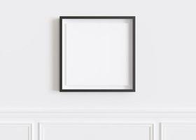 Blank square picture frame hanging on white wall. Template, mock up for your artwork, picture or poster. Empty, copy space. Close up view. Simple, minimalist mockup. 3D rendering. photo