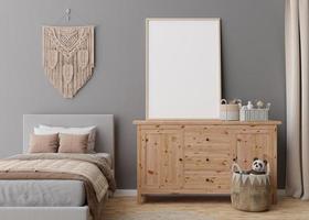 Empty vertical picture frame on grey wall in modern child room. Mock up interior in scandinavian, boho style. Free, copy space for your picture. Bed, macrame, toys. Cozy room for kids. 3D rendering. photo