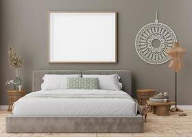 Empty picture frame on grey wall in modern bedroom. Mock up interior in boho style. Free, copy space for your picture, poster. Bed, rattan table, pampas grass, macrame, cat. 3D rendering. photo