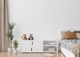Empty white wall in modern child room. Mock up interior in scandinavian style. Free, copy space for your picture, poster. Bed, rattan basket, toys. Cozy room for kids. 3D rendering. photo