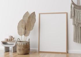 Empty vertical picture frame standing on parquet floor in modern living room. Mock up interior in scandinavian, boho style. Free space for picture. Macrame, rattan basket. 3D rendering. photo