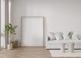 Empty vertical picture frame standing on parquet floor in modern living room. Mock up interior in scandinavian style. Free, copy space for picture. Sofa, plants. 3D rendering. photo