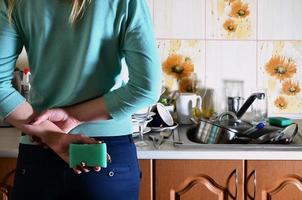 Fragment of the female body at the kitchen counter, filled with photo