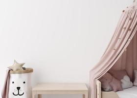 Empty white wall in modern child room. Mock up interior in scandinavian style. Copy space for your picture or poster. Bed, table, toys. Close up view. Cozy room for kids. 3D rendering. photo