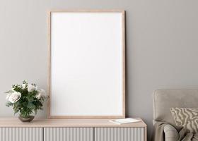 Empty vertical picture frame on cream wall in modern living room. Mock up interior in minimalist, scandinavian style. Free space for picture. Console, flowers in vase, armchair. 3D rendering. photo
